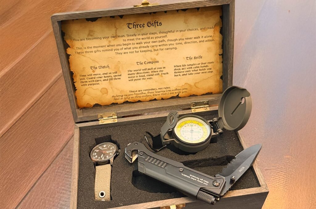 Open Points North Collection gift box showing a watch, compass, and knife inside a black wooden case with parchment inscription.